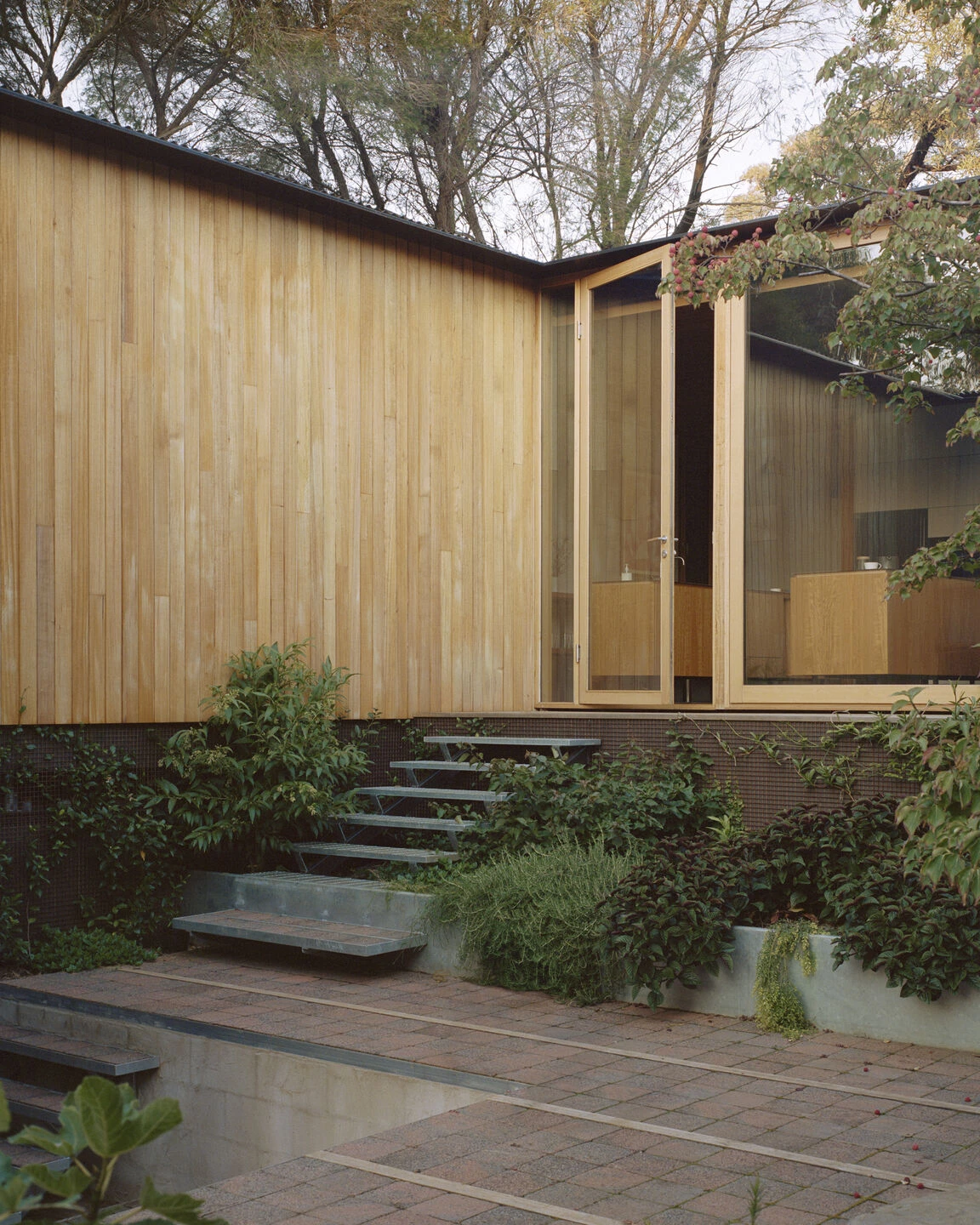 Wood-paneled courtyard house - entrance view