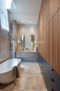 modernist glass box extension 1890 cottage - bathroom